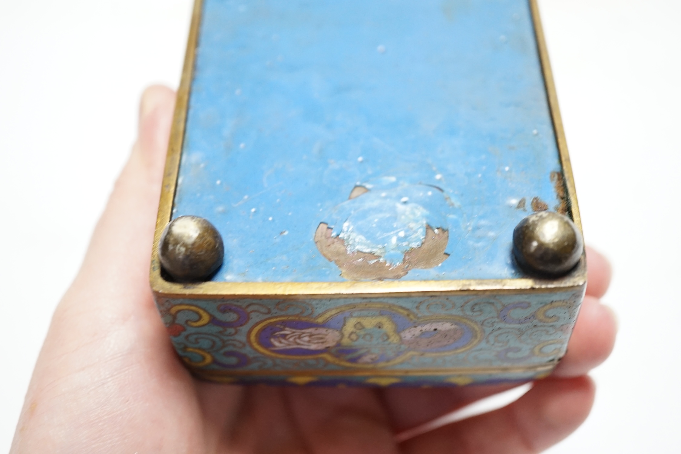 Seven Chinese or Japanese cloisonné enamel items including a pair of candlesticks, 15cm high, a charger, two boxes and a pair of vases